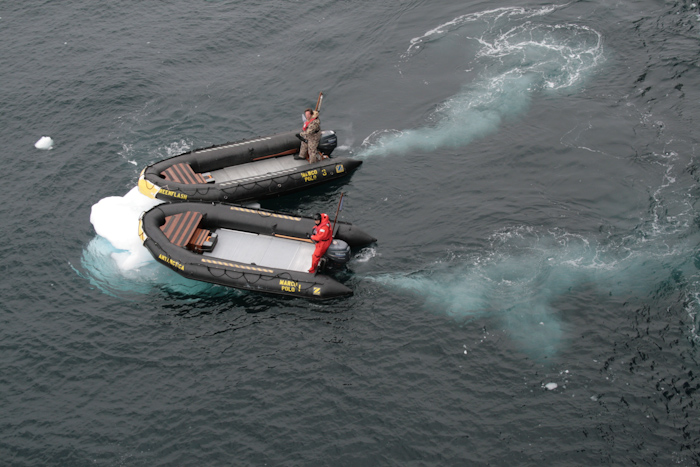 Zodiac semi-inflatables, here seen pushing small icebergs away from the (comparatively delicate) tender embarkation platform that hugs the side of the ship at the waterline (2007).