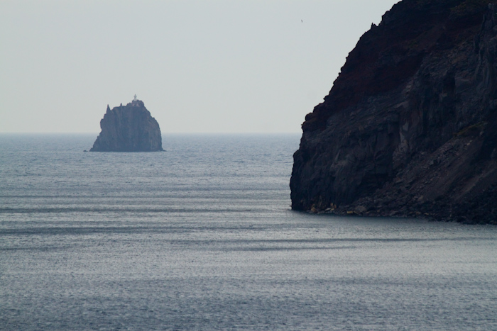 Looking past the edge of Stromboli to the weird shaped island rock of Strombolicchio.
