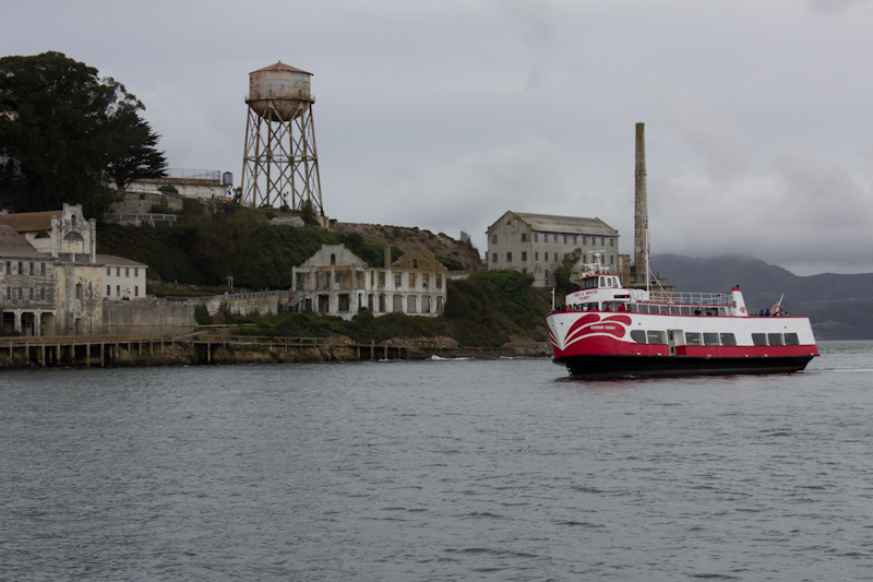 Alcatraz and a tourist boat. There were so many people on the sight seeing boat that when they all went to one side to look at Alcatraz, the boat tipped to starboard quite visibly. How many people on the catamaran? Five.