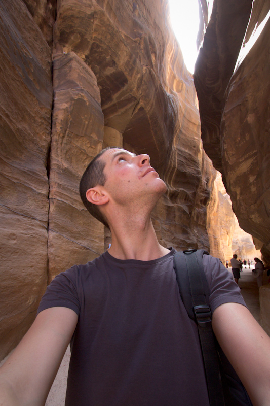 Petra, Jordan: Me looking up at the very narrow gorge.
